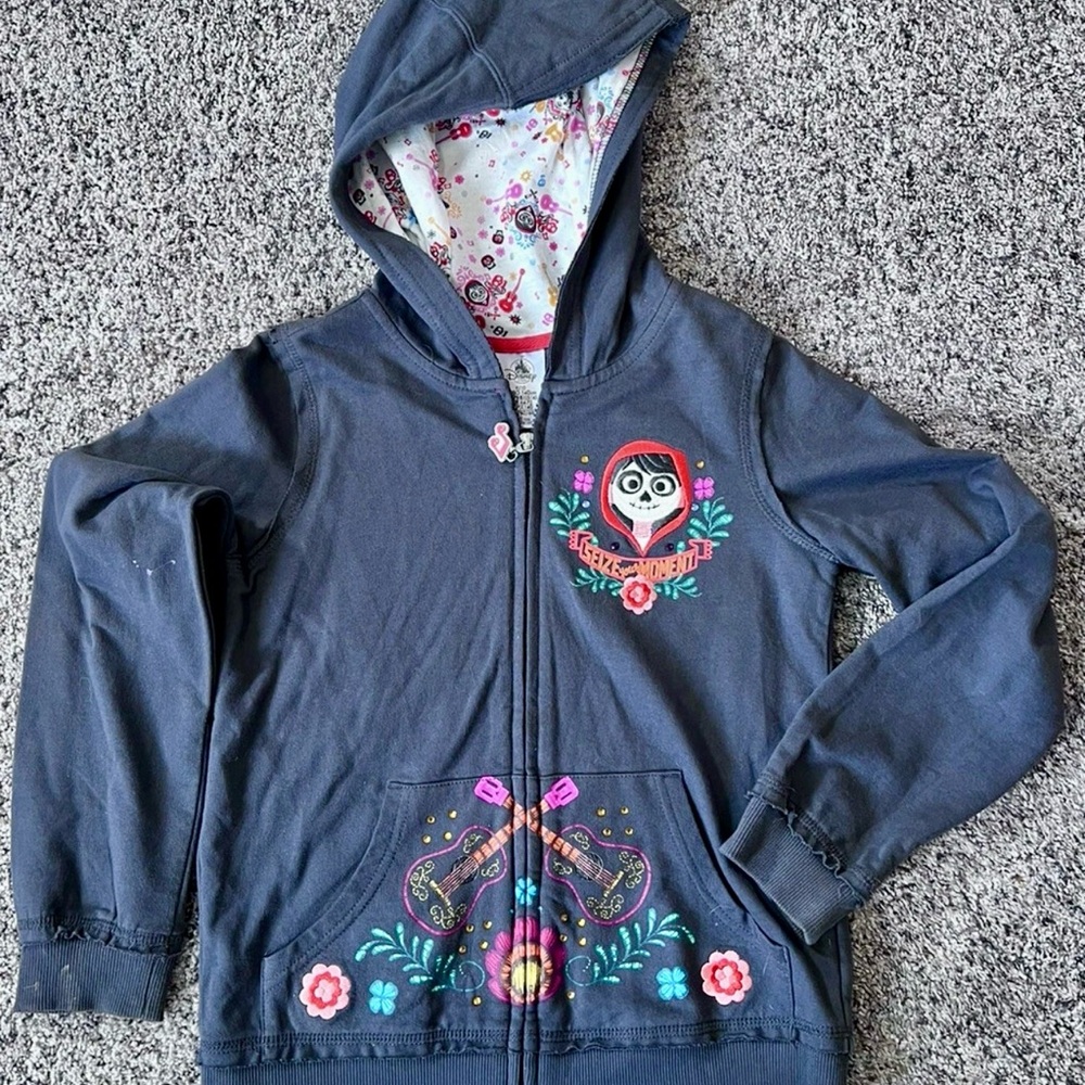 Pre worn grey kids’ Disney store Coco zip-up jacket- size: 9/10